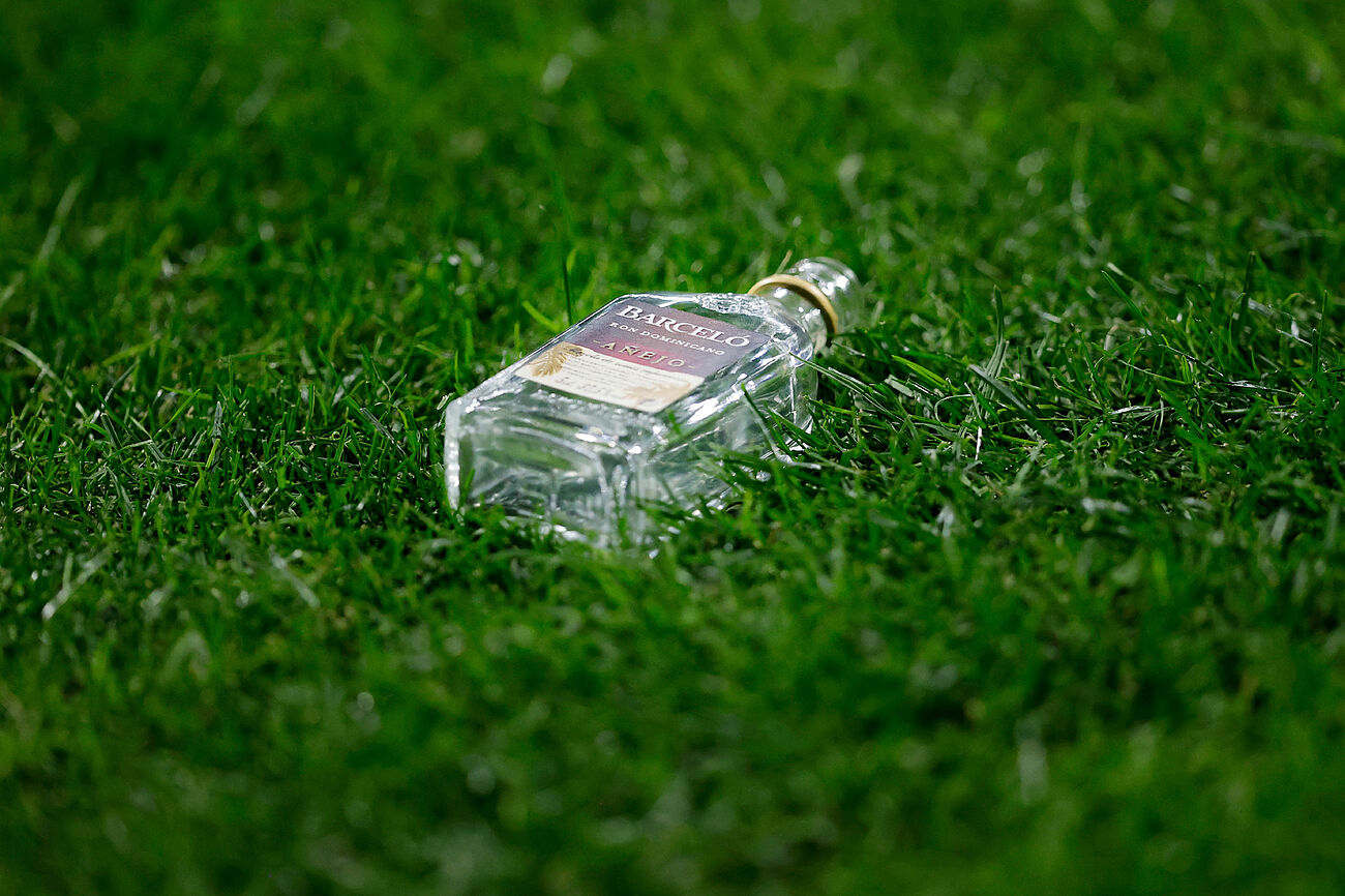 زجاجة خمر على أرض الملعب